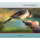 Ein Spatz frist aus einer Menschenhand